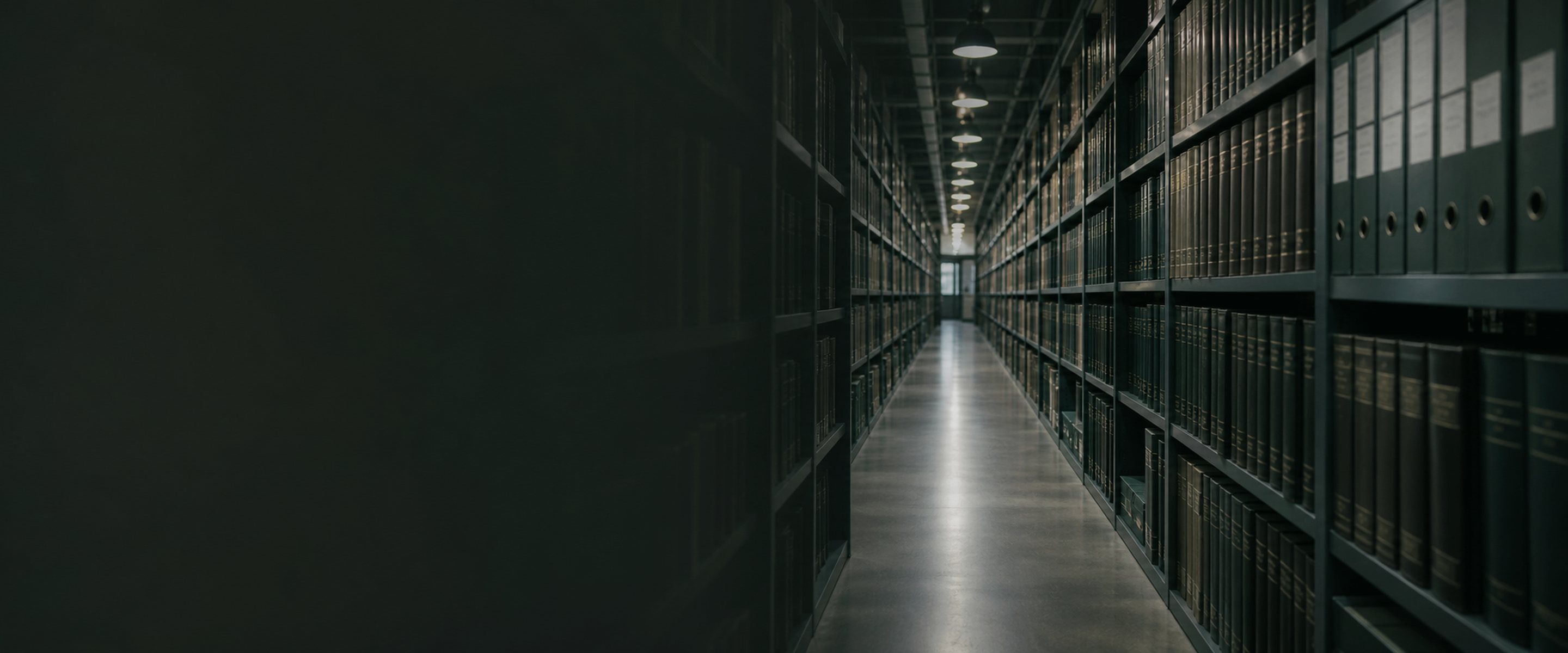 A long archive corridor of bound patent volumes